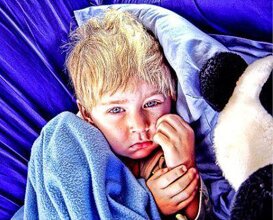 Donate Your Car to Help a Child With Cancer TODAY! picture of a kid with a blanket who could benefit from a charity donation